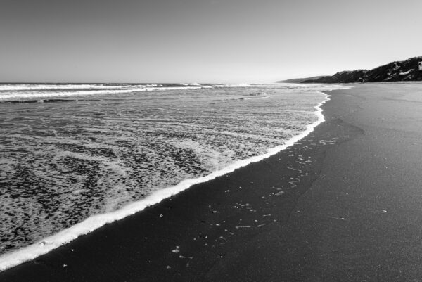 Black and white coastal ocean waves.